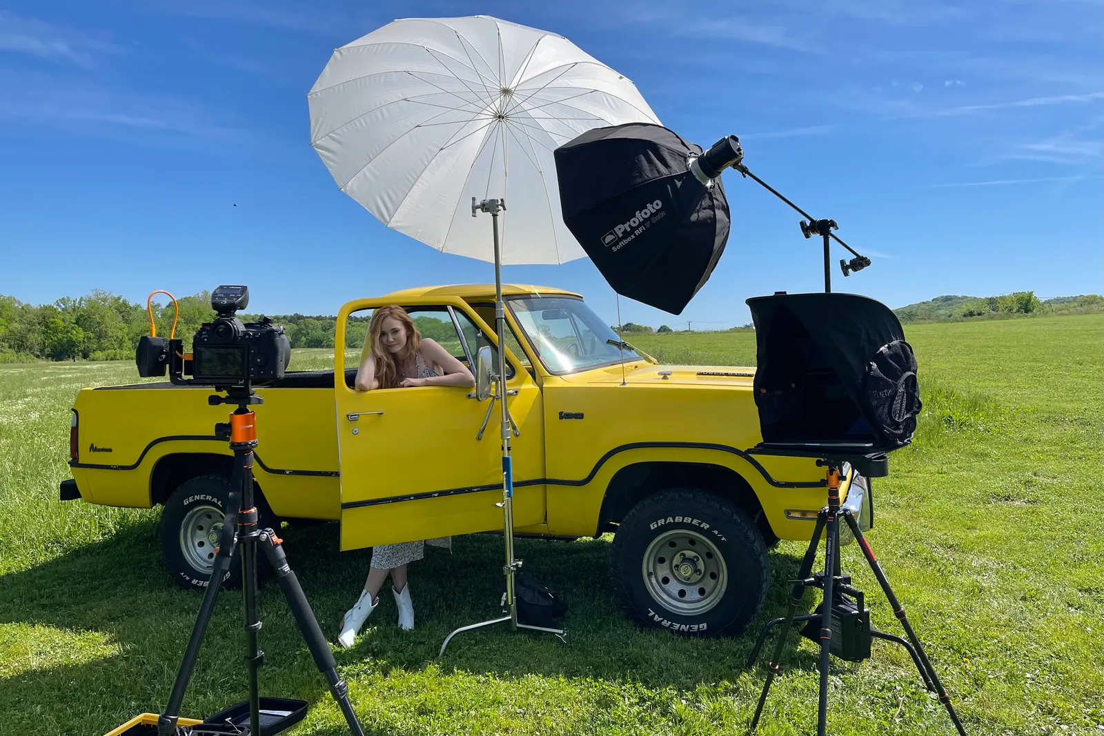 Outdoor lighting setup with a vintage yellow truck