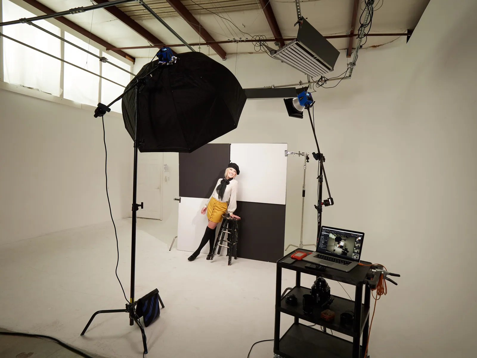 Studio lighting setup with an octabox and a seated model